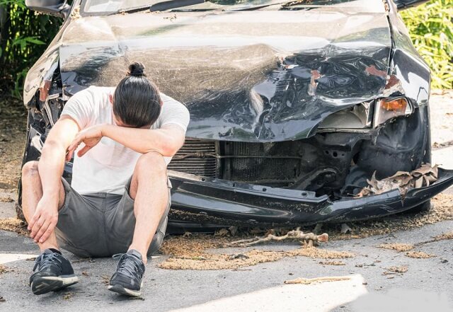 a person with a damaged car